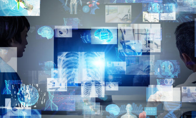 Two doctors looking at screens with body parts on them