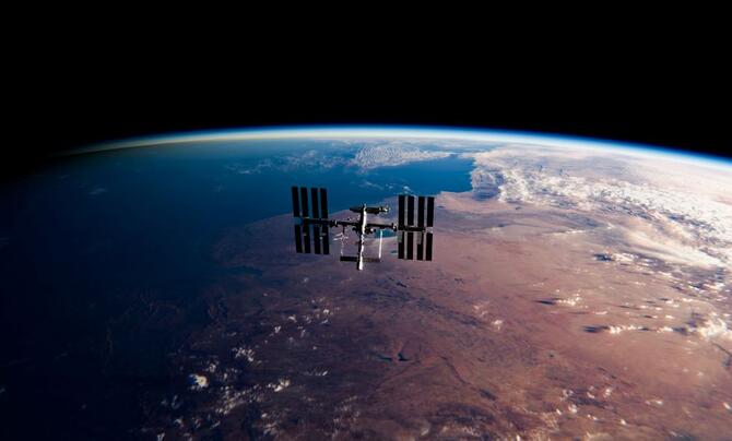A photograph of the International Space Station taken from space with Earth in the background