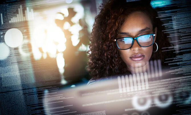 Women looking at monitor with reflection in her glasses