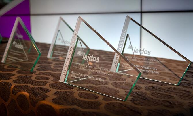 Four Leidos trophies laid out on a table