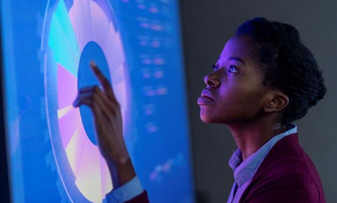 A woman touching a screen