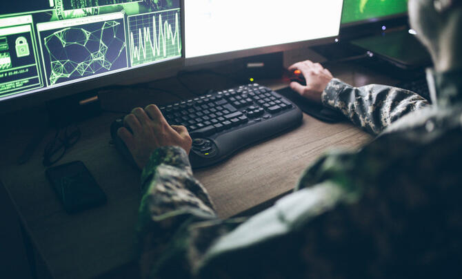 Military man working at a computer