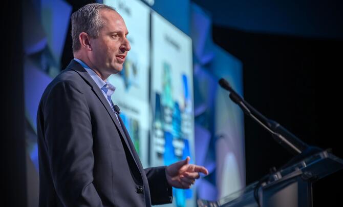 Doug Jones speaking at a podium