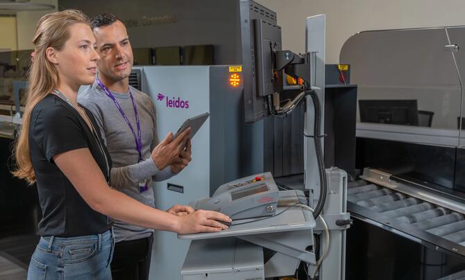 Leidos employees working at a airport security checkpoint