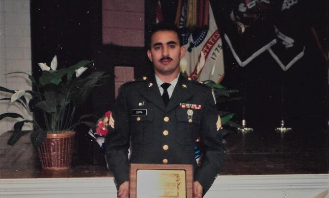 Jeff Coppa standing with an award