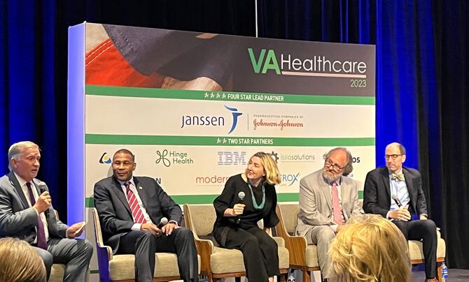 5 people sitting at a panel