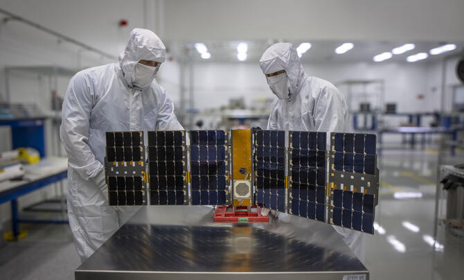 Test Engineers prepare the Lonestar Tactical Space Support Vehicle in Leidos Dynetics facility clean room.  The Lonestar program officially completed its extended journey in orbit in December. (Gary Gee/Leidos Dynetics)