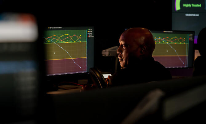 A man looks at data on a computer screen.