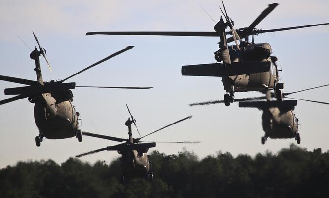 U.S. Army UH-60 Black Hawks take off in a multi-ship formation for training.