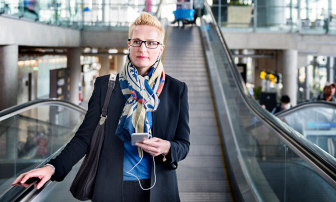 woman standing on escalator