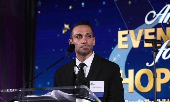 Milad Brahrami speaking at an Evening for Hope gala
