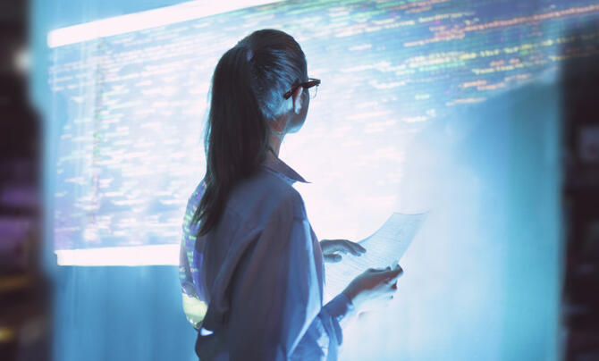 Female engineer looks at computer