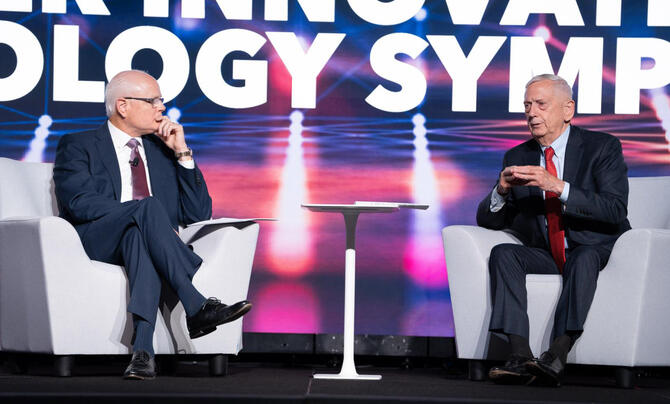 Leidos CEO Tom Bell (left) and retired Gen. James Mattis (right) discuss the ways industry can deliver technology to complex government missions. (Visuals by J. McKenzie)