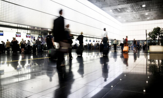 people walking by security line at airport