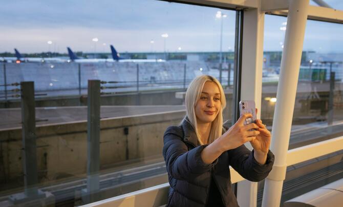 woman taking selfie at airport
