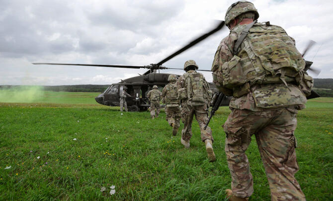 soldiers en route to helicopter
