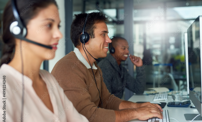 Employees taking calls at a military health contact center