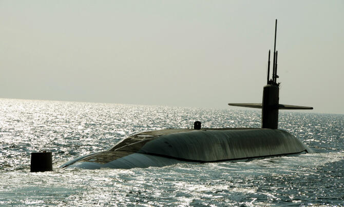 A submarine emerges from the ocean.