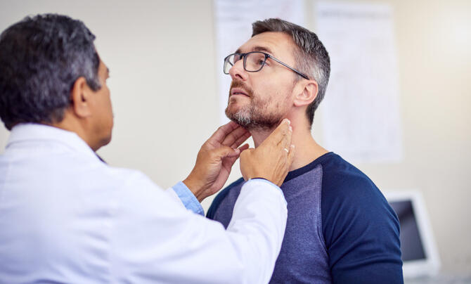 A male medical provider examines a male patient.