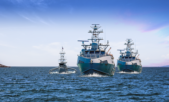 Three ships travel across the ocean.