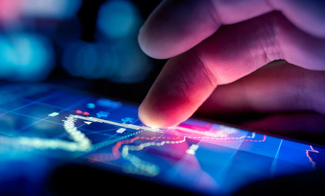 A hand moves across a touchscreen.