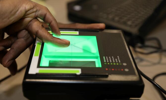 A person scans their fingerprints