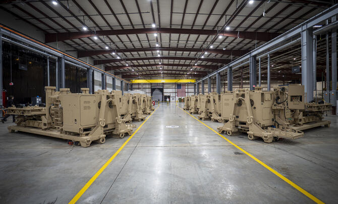 Multiple launchers are lined up in a warehouse.