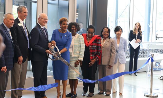 Leidos CEO Tom Bell and Drake State President Dr. Patricia Sims cut the ribbon for the Leidos Advanced Training Complex.