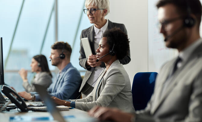 A manager monitors a team in a call center