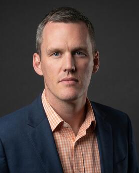 Man in a suit looking at background