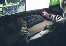 Offensive cyber operator sits at their desk 