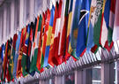 A long row of different country flags displayed next to each other at the Department of State 
