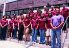 Group of high school students, educators, and Leidos representatives pose outside North Carolina Central University during a STEM program focused on artificial intelligence and emerging technologies.