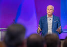 Leidos CEO Tom Bell addressing audience