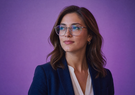A woman has code reflected in her glasses