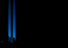 Two blue Tribute in Light beams rise into the night sky above the dark silhouette of Lower Manhattan.
