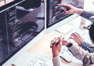 Professionals pointing at a computer monitor