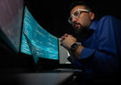 Man looking at screen of code