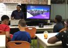 Aaron Dorsey mentoring a group of students in classroom