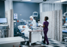 patient in hospital bed with doctor consulting