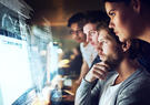 people looking at monitor 