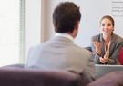 Woman talking to man in interview setting