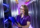 female wearing leidos polo shirt with tablet