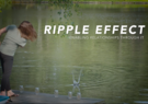 woman throwing stone into pond