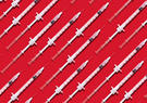 syringes on red backdrop 