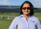 Photo of Amruta Kalvit with solar arrays in background
