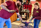 Man and woman blacksmithing