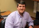 Photo of rotational program participant at his desk