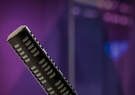 A podcast studio with a microphone and Leidos colors in the background