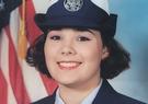 Melissa Tamayo in military uniform in front of the American flag